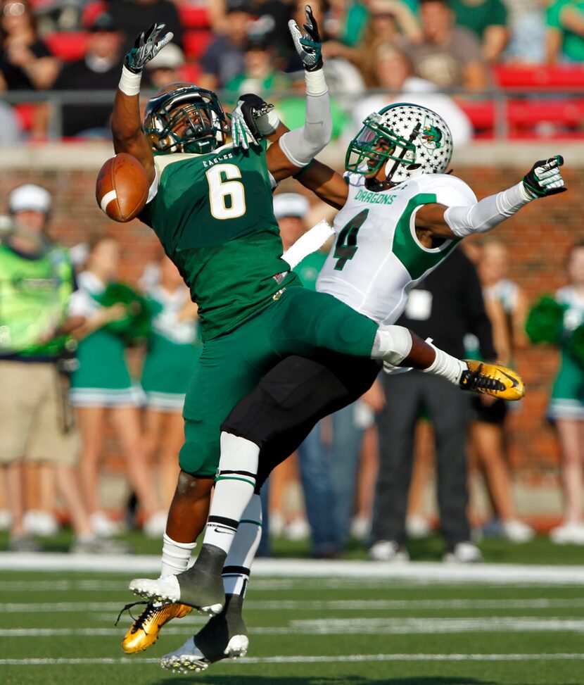 DeSoto High's Brandon McDowell (6) and Southlake High's Ray Crockett (4) battle for a pass...