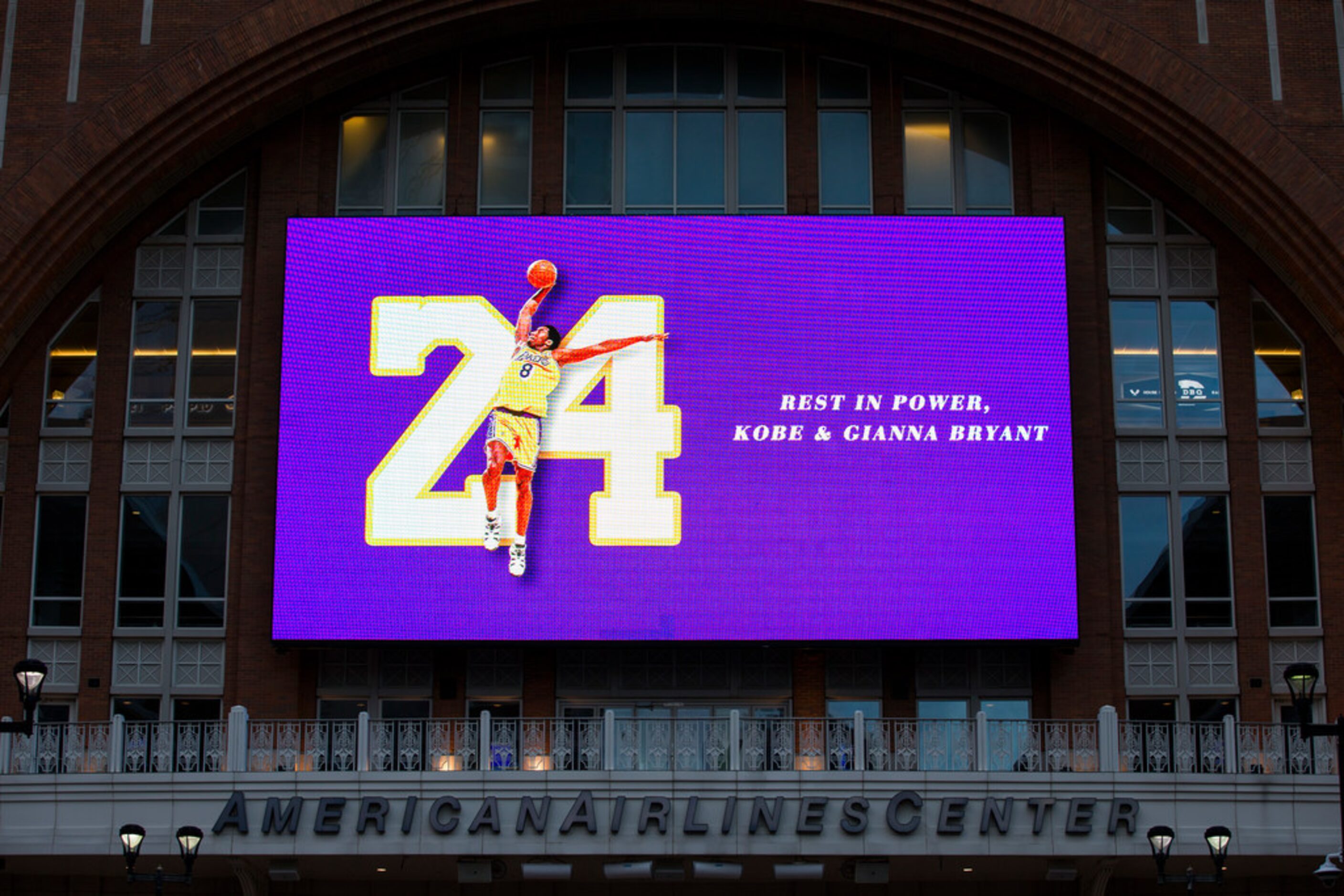 Large screens display a tribute to former Los Angeles Laker Kobe Bryant and his daughter,...