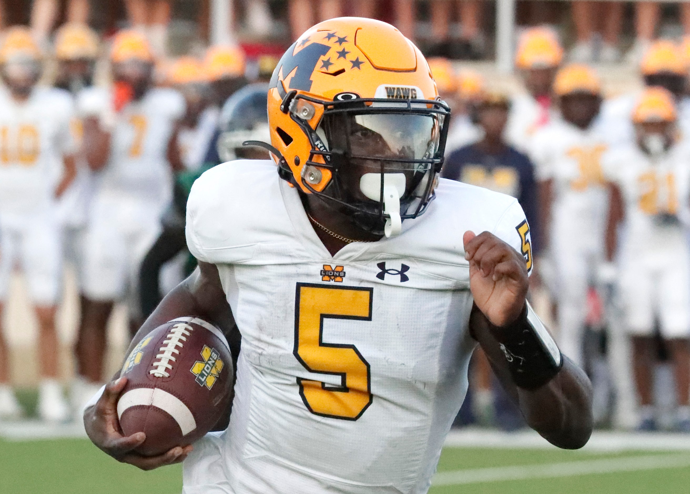 McKinney High School quarterback Godspower Nwawuihe (5) runs the ball during the first half...