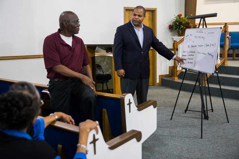 State Rep. and Dallas mayoral candidate Eric Johnson chats with a Bible study group at...