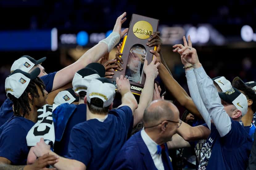 UConn celebrates with the trophy after their win against Purdue in the NCAA college Final...