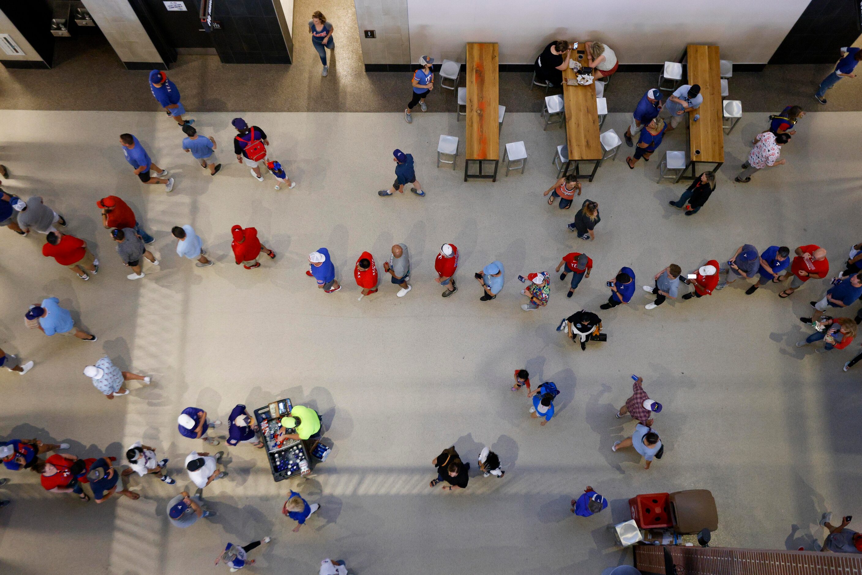 Fans wait in line for concessions during the Texas Rangers’ home opener against the Colorado...