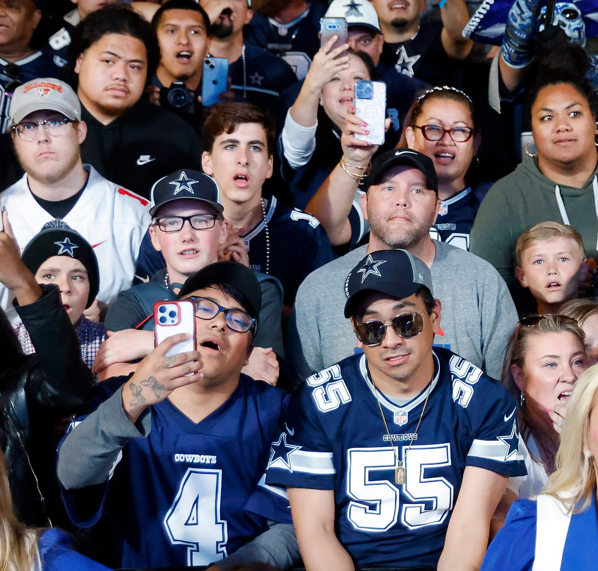 Dallas Cowboys fans cheer the teams first round pick in the NFL Draft during a draft party...