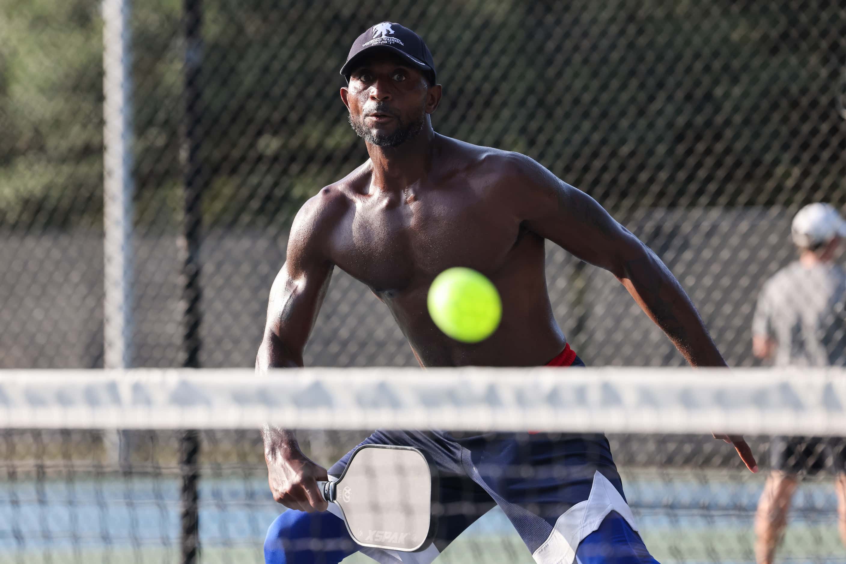 Kirk Wilson watches the ball during a doubles game of pickleball at Dallas' Cole Park. 