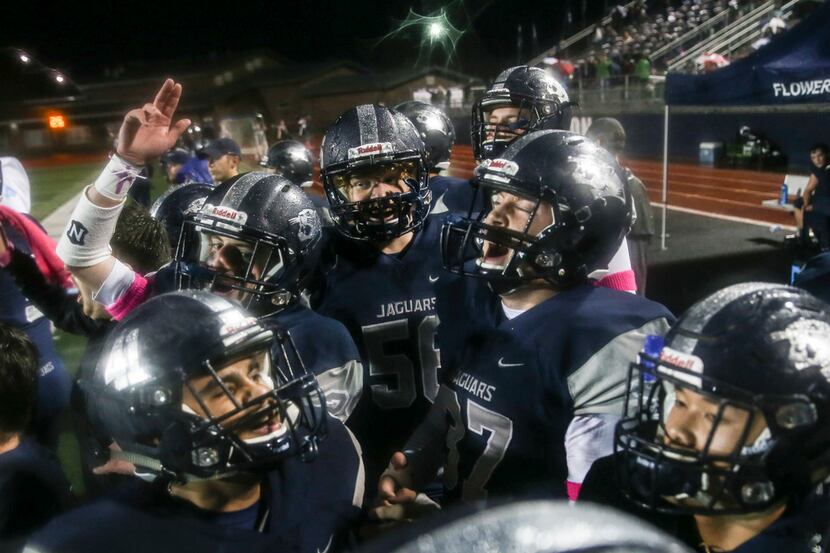 The Flower Mound sideline reacts to a play during the first quarter of a matchup between the...