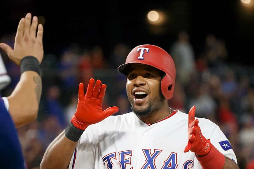 Texas Rangers shortstop Elvis Andrus celebrates after touching home after hitting a 3-run...
