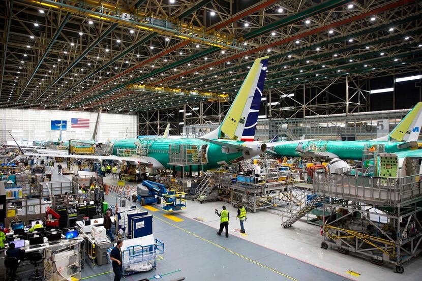 Employees work on Boeing 737 MAX airplanes at the Boeing Renton Factory in Renton, Wash., in...