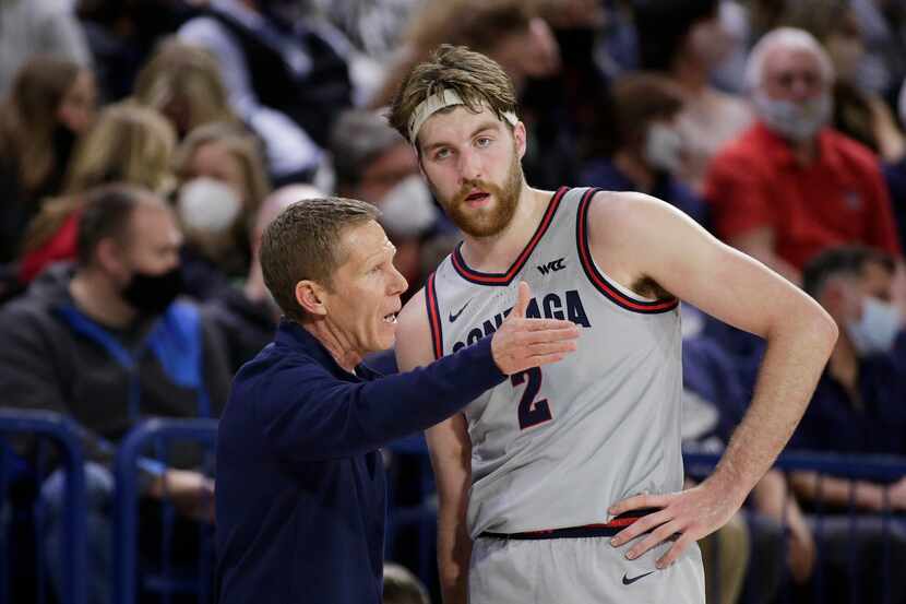 FILE - Gonzaga head coach Mark Few, left, speaks with forward Drew Timme (2) during the...