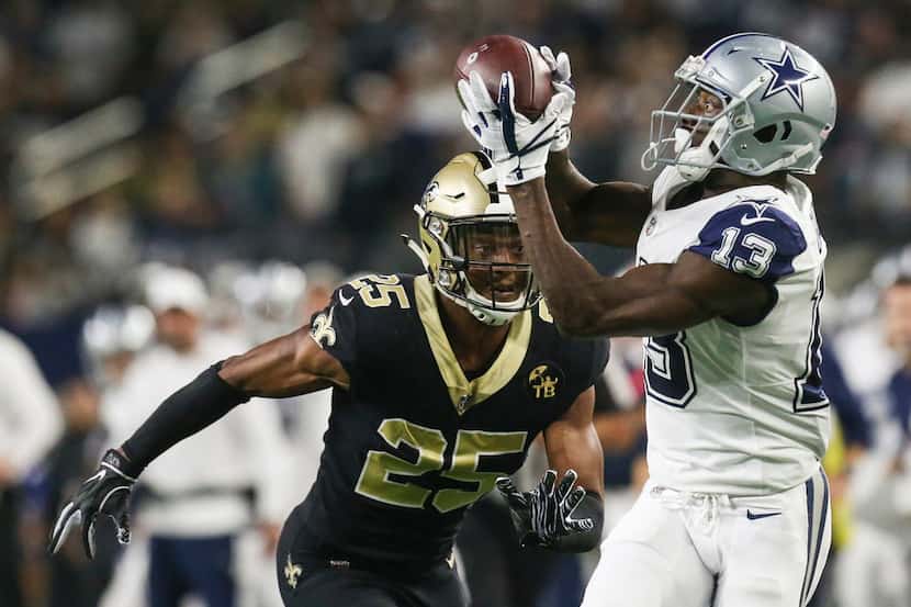 Dallas Cowboys wide receiver Michael Gallup (13) receives a pass over New Orleans Saints...