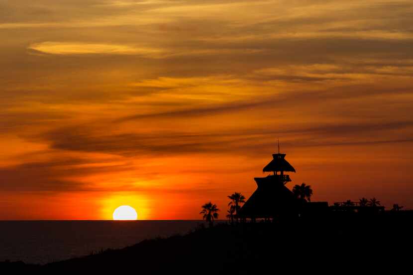 The sun sets behind the oceanfront El Mirador restaurant in Todos Santos, Mexico.