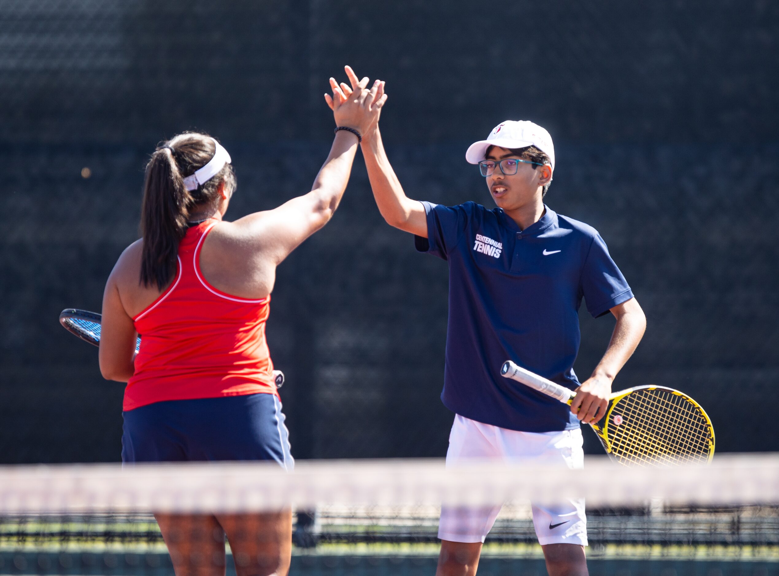 Frisco Centennial’s Aashikha Basappa, left, high-fives Akshay Kommineni during a mixed...