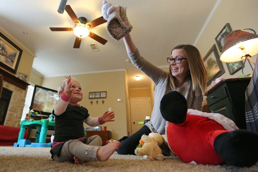 Kelley McKissack, right, plays with her one-year-old daughter Kelcey, in Nevada on Thursday....