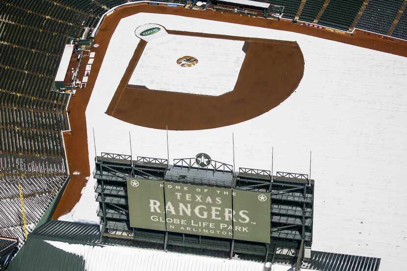 Snow covers the field at Globe Life Park after a record snowfall on Thursday, March 5, 2015,...