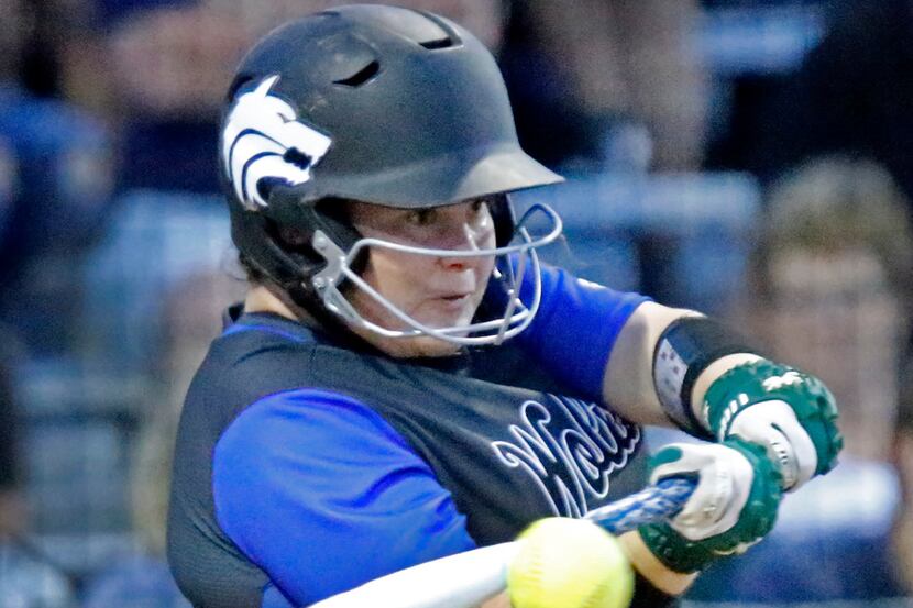 Plao West catcher Tatum Boyd gets a solid hit in the fifth inning as Plano East High School...