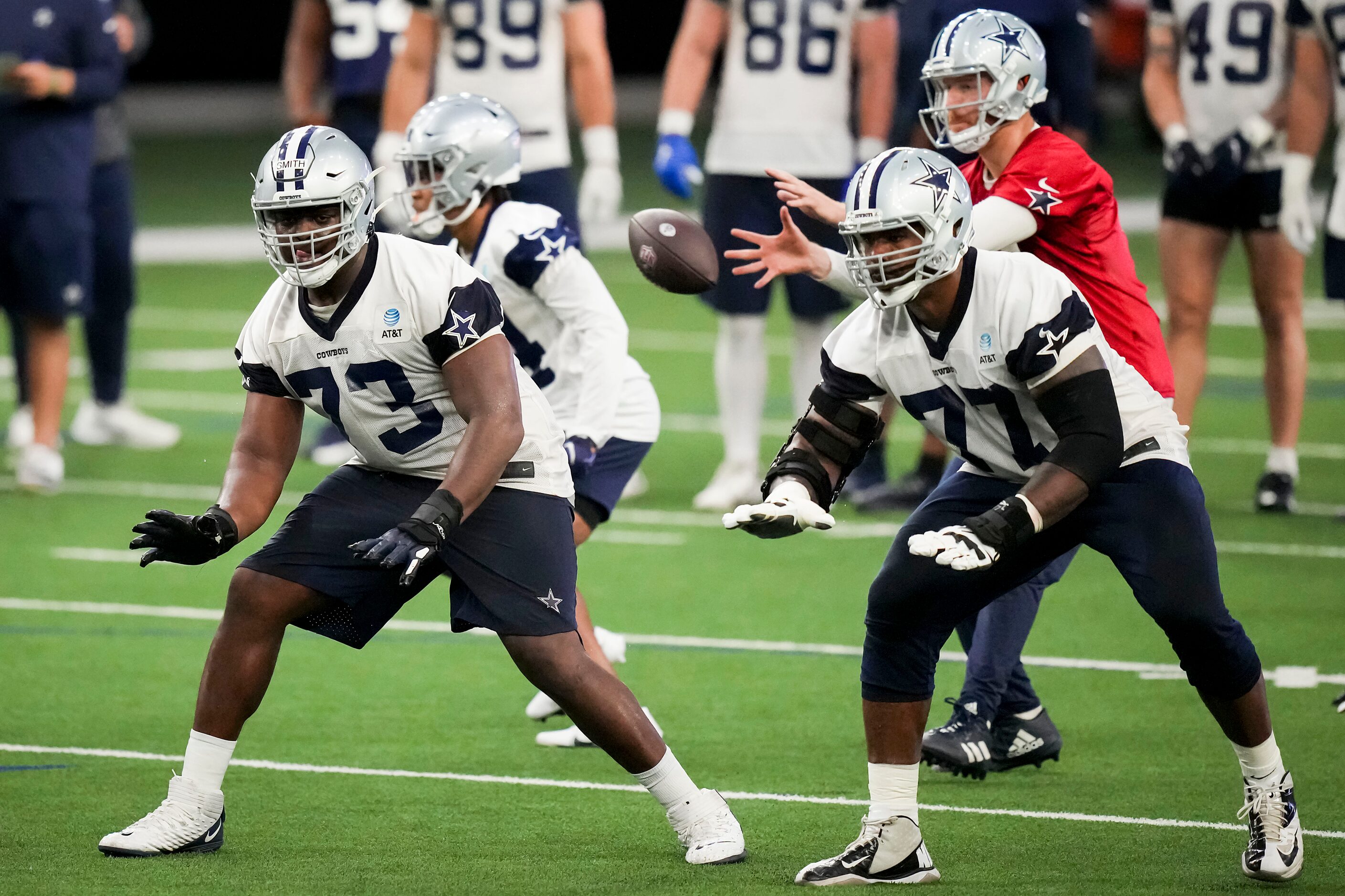 Dallas Cowboys offensive lineman Tyler Smith (73) works alongside tackle Tyron Smith (77)...