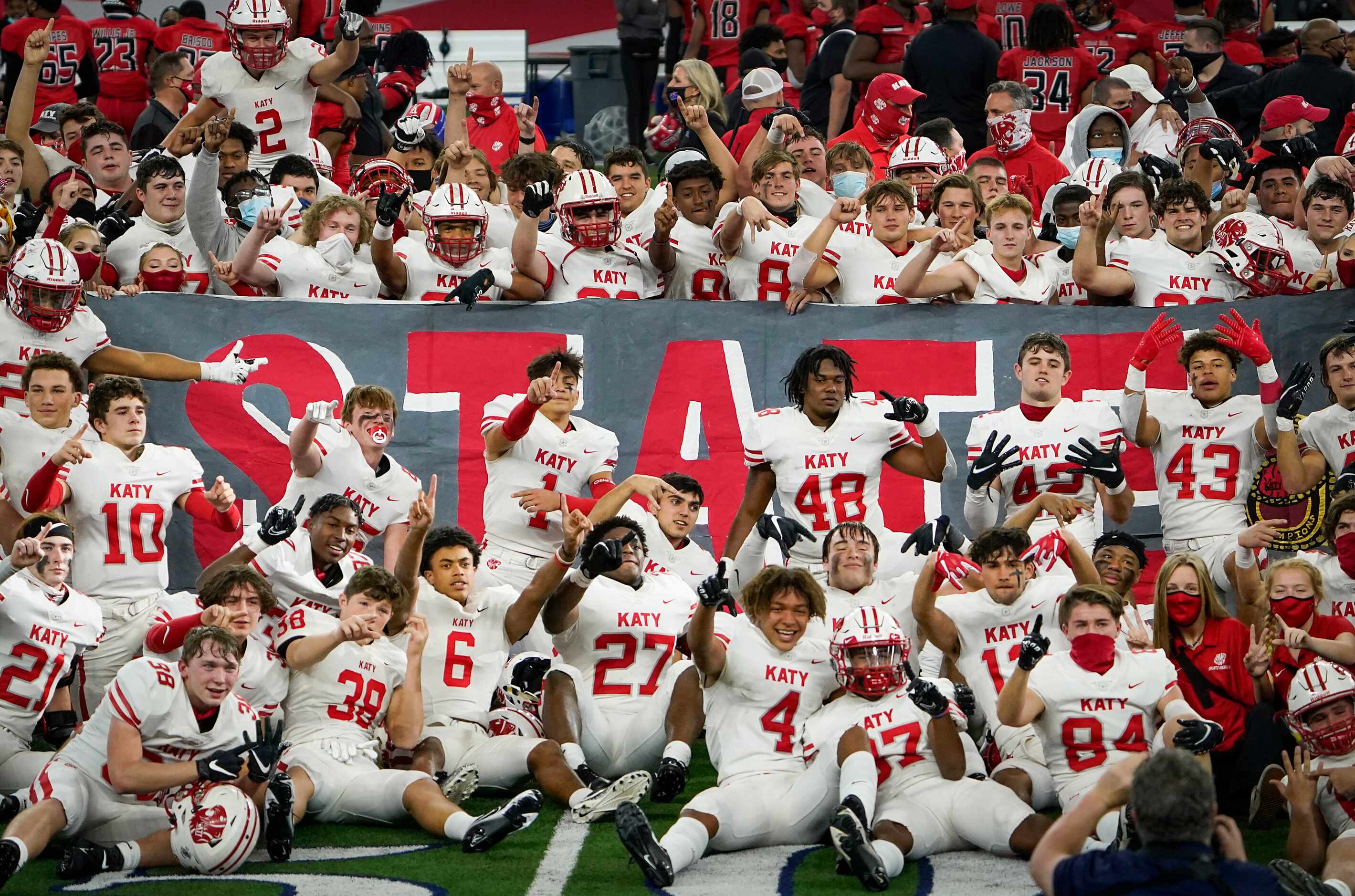 Katy players celebrate their victory over Cedar Hill in the Class 6A Division II state...