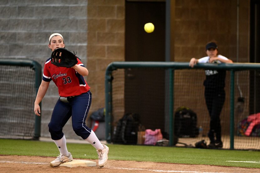 Ryan first basemen Abby Buettner reaches to catch the ball to tag out a runner. Wichita...