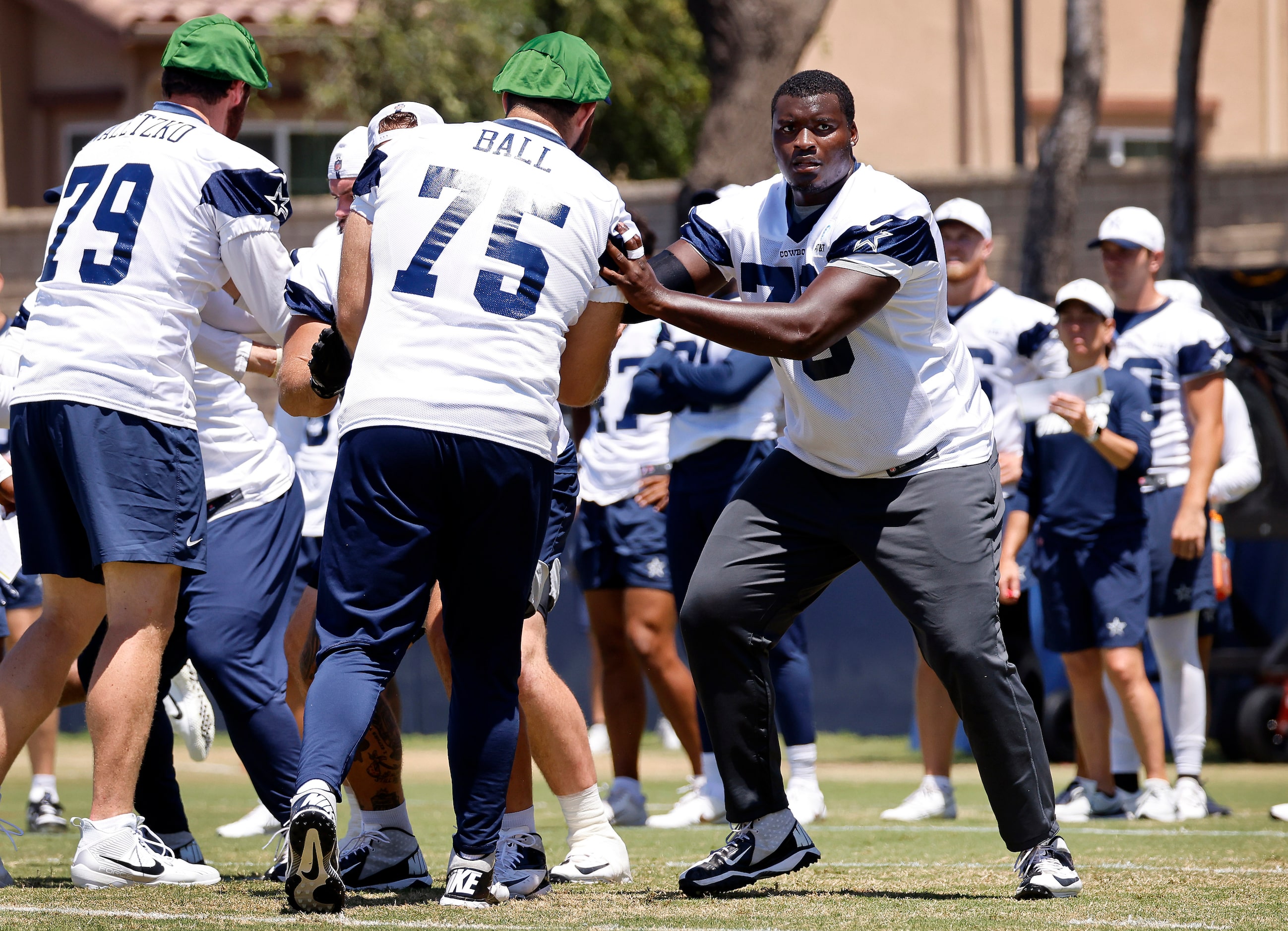 Dallas Cowboys offensive tackles Asim Richards (76) and Josh Ball (75) block one another...