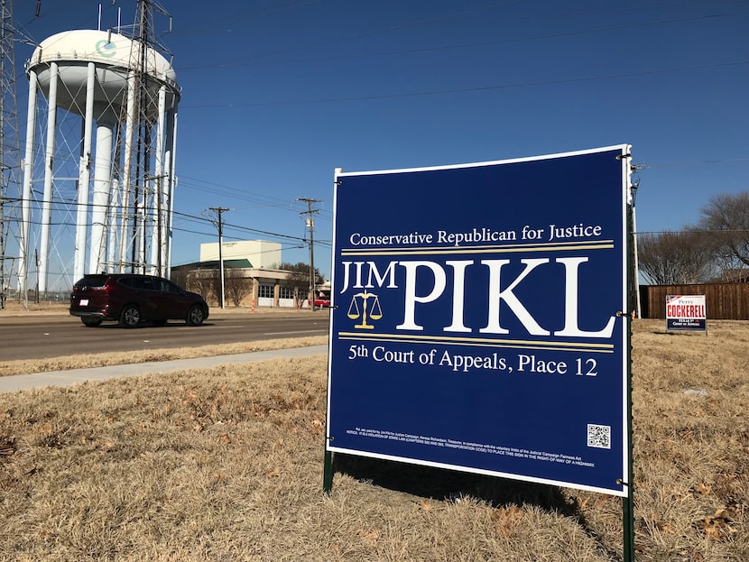 Two political signs sit on a vacant lot near Josey Lane in Carrollton on Jan. 18, 2018. 