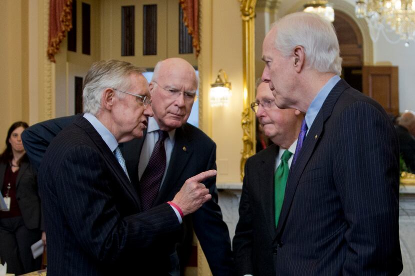 In this Feb. 12, 2014, photo, Senate Majority Leader Harry Reid, D-Nev., from left, Sen....