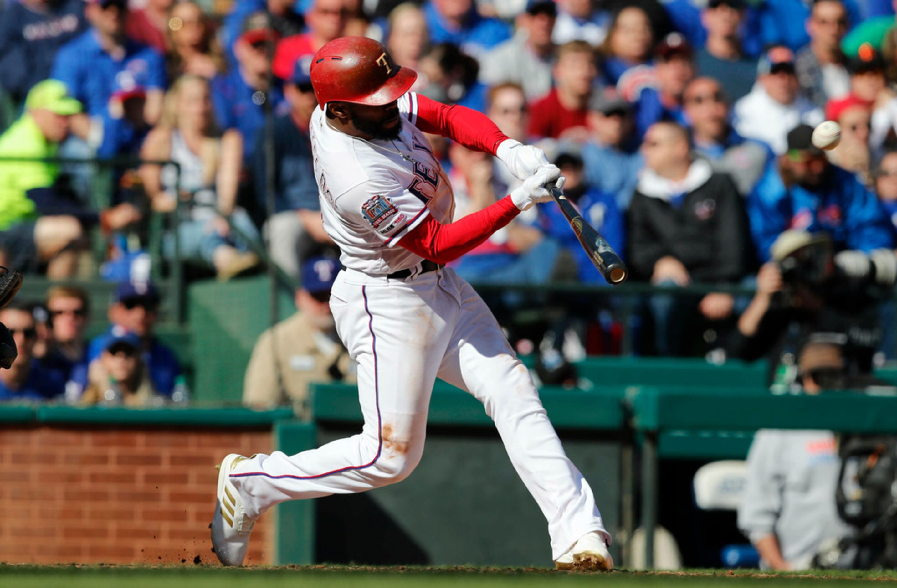 Texas Rangers' Delino DeShields hits a grand slam during the fourth inning of a baseball...