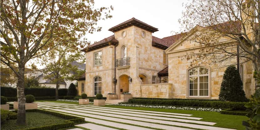 Limestone slabs make for a beautiful addition to this Mediterranean-style home's curb appeal.