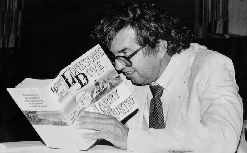 Pulitzer prize winning author Larry McMurtry autographs a copy of Lonesome Dove during a...