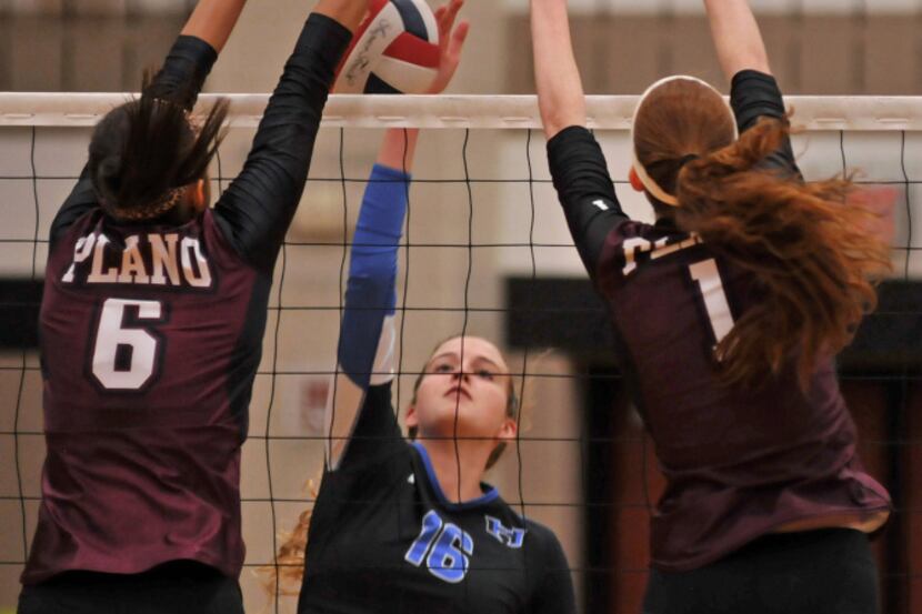 Hebron junior Brookah Palmer (16) deals with a block by Plano senior Kylie Long (6) and...