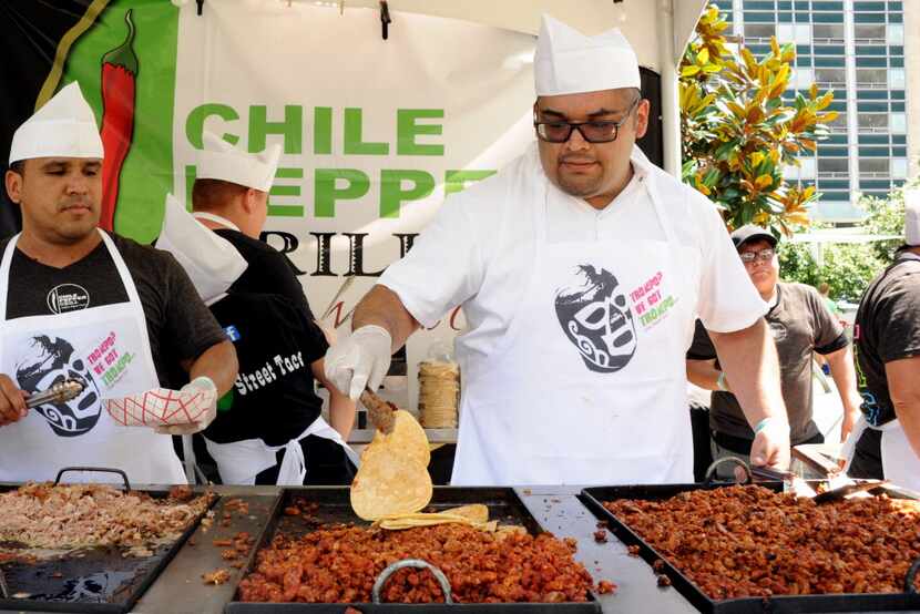 Chile Pepper Grill chef prepares tortillas at Taco Libre at Main Street Garden in Dallas, TX...