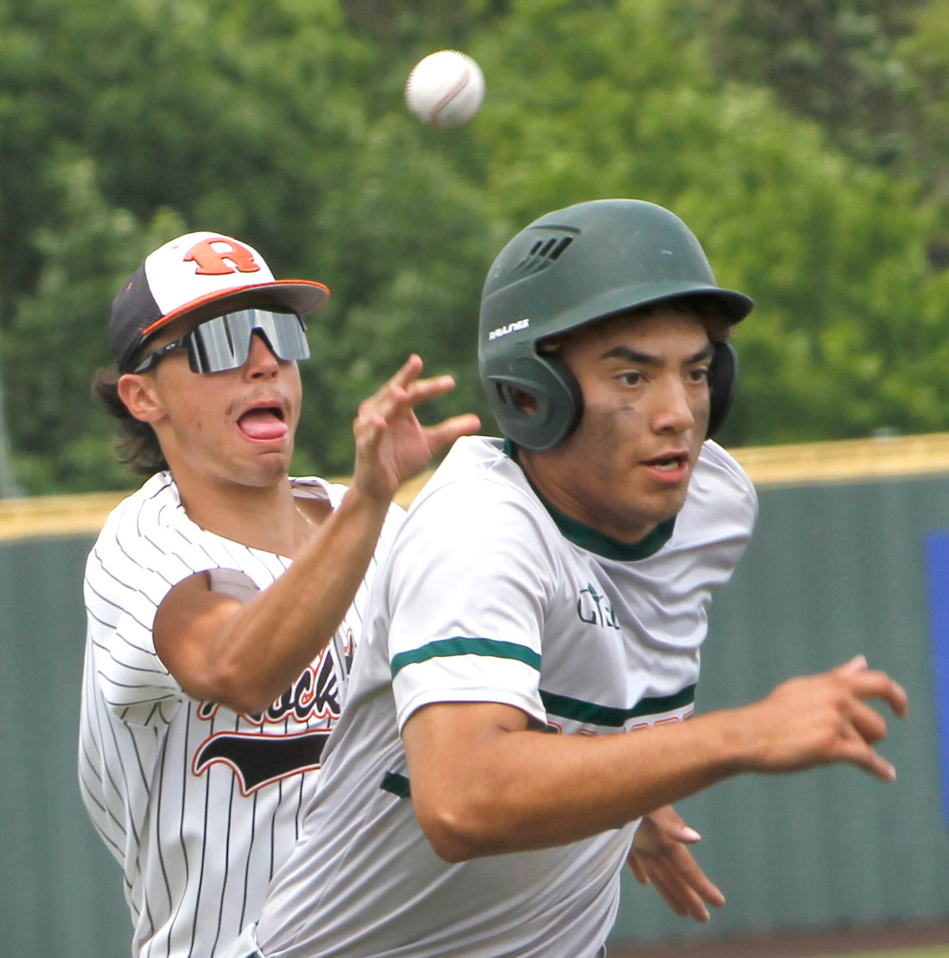 Garland Naaman Forest freshman Jason Flores (4), right, gets caught in a rundown off 3rd...