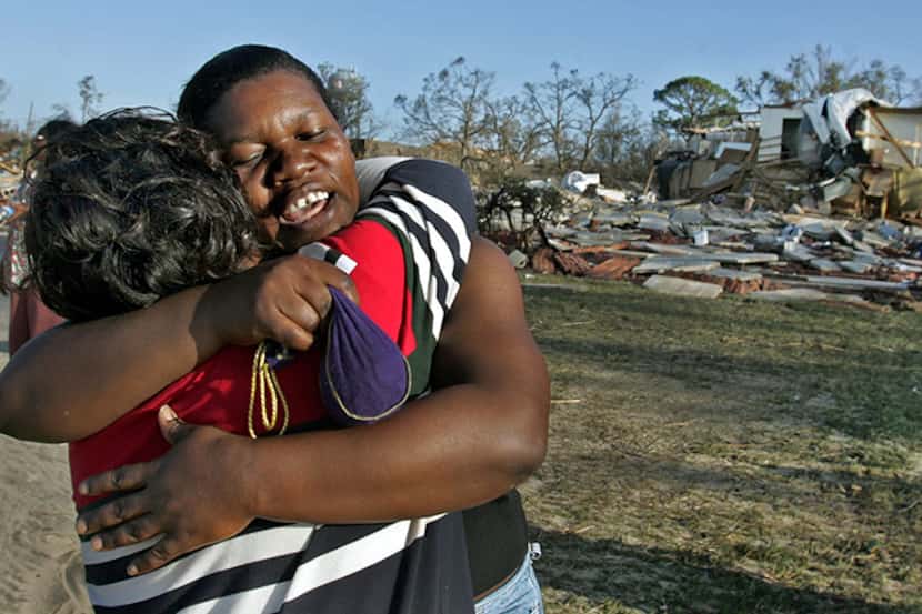  August 30, 2005--Roxona Park, from Jamaica, gets a hug from her friend Althea Brown as they...