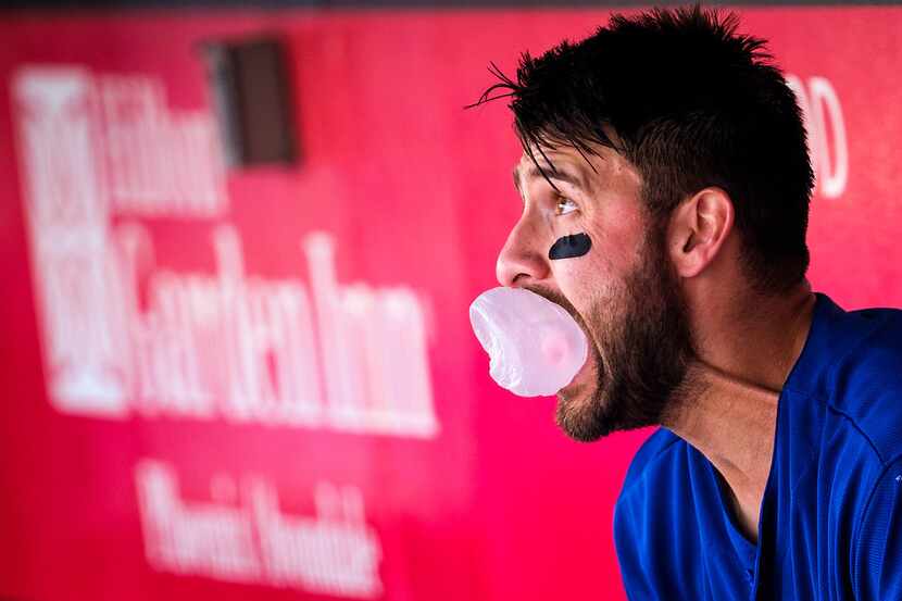 Texas Rangers outfielder Joey Gallo blows bubbles in the dugout during a spring training...