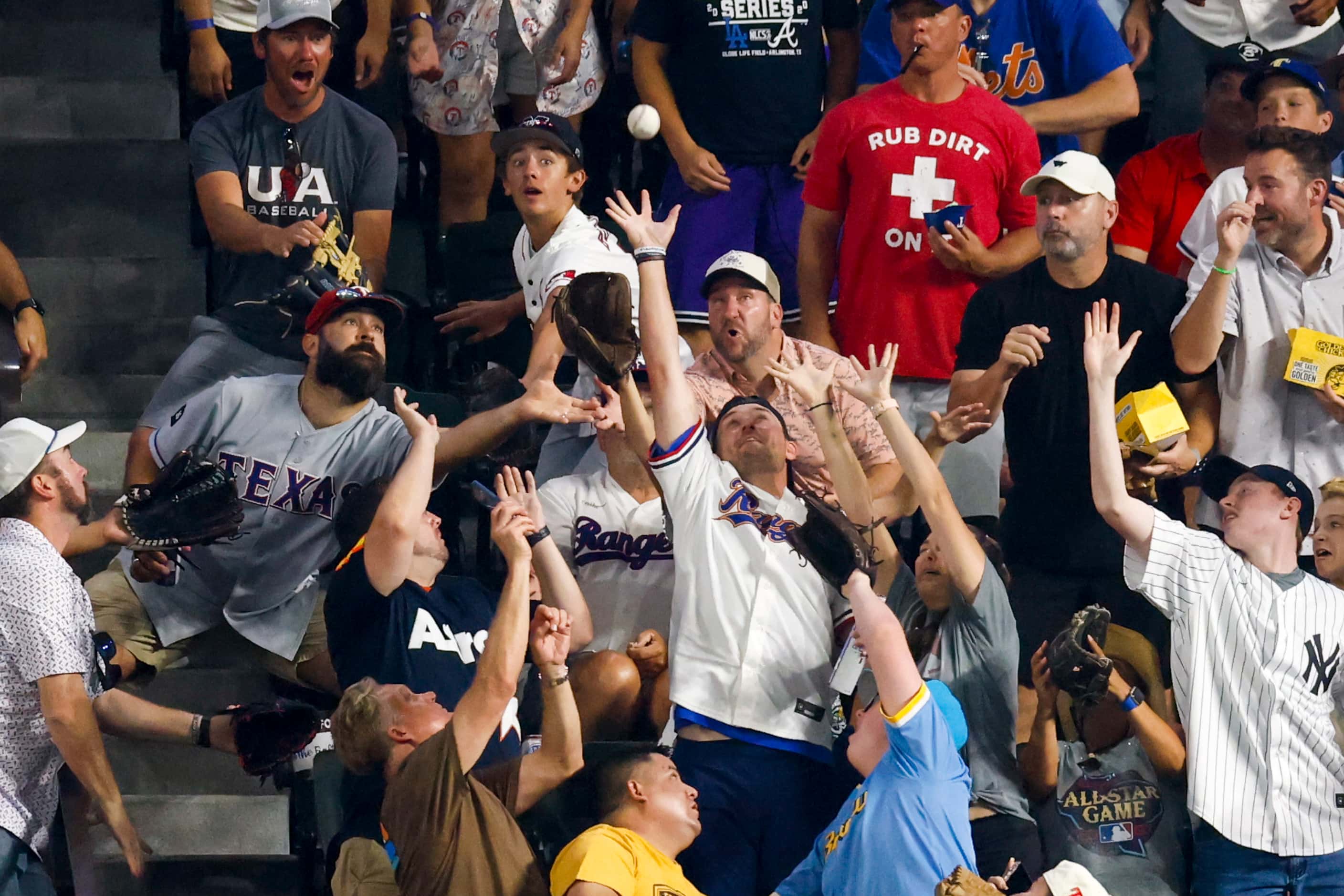 Fans try to catch a home run ball hit by National League's Shohei Ohtani, of the Los Angeles...