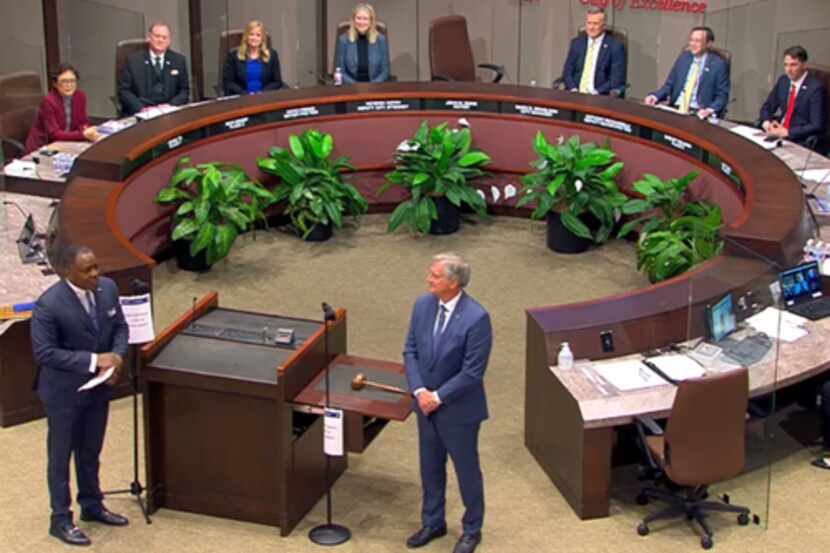 Plano's outgoing mayor, Harry LaRosiliere (front left) talks with new Mayor John Muns during...
