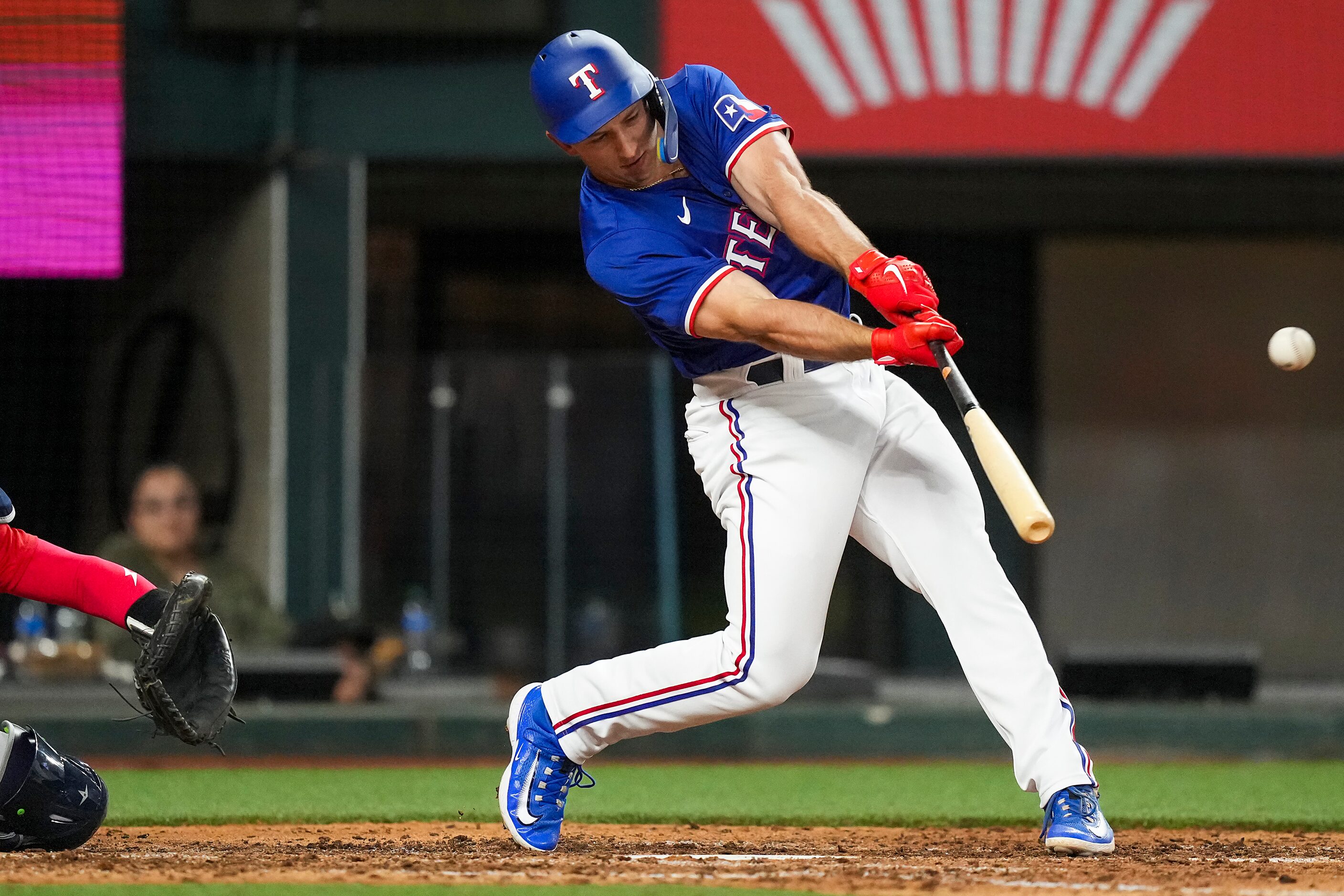 Texas Rangers designated hitter Wyatt Langford flies out to left during the seventh inning...