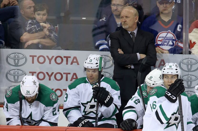 Dallas Stars' coach Lindy Ruff and his bench look dejected during the loss to the Winnipeg...