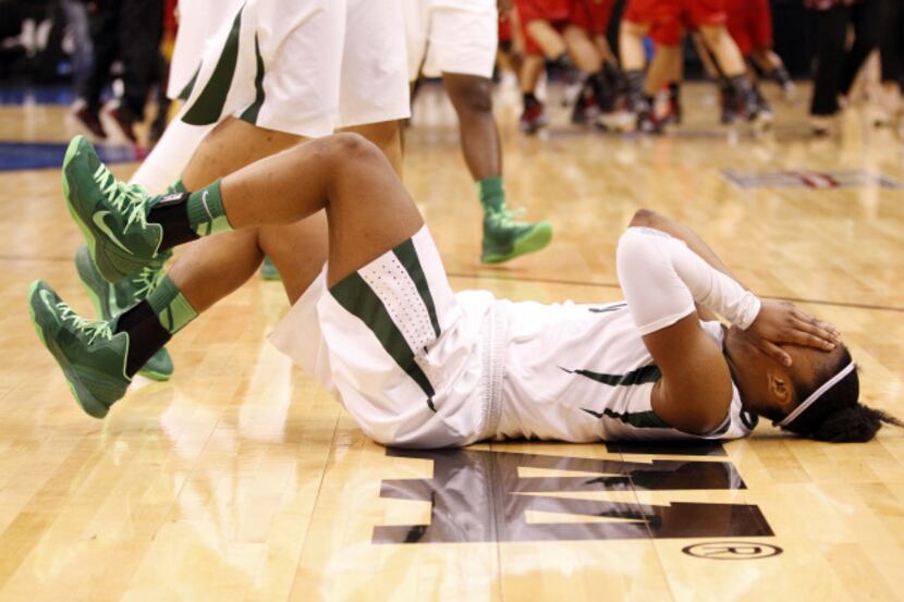 Baylor Bears guard Odyssey Sims (0) cries as Louisville Cardinals celebrates a victory at...