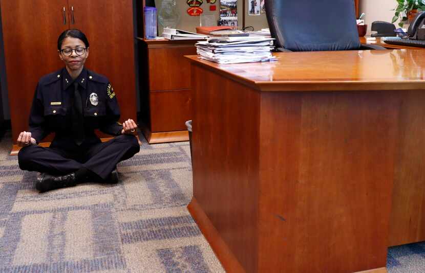 Dallas Police Department Assistant Chief Tammie Hughes demonstrates how she meditates in her...