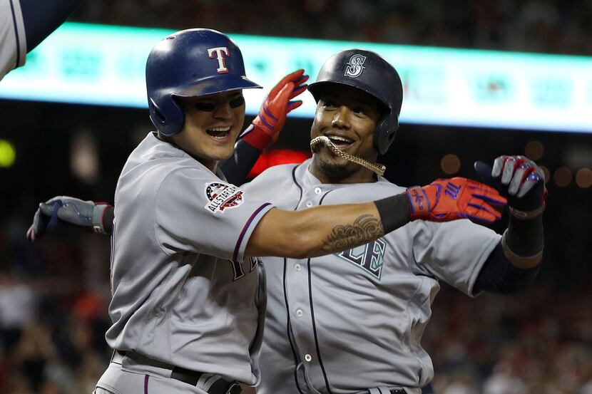 Jean Segura of the Seattle Mariners and the American League celebrates with Shin-Soo Choo of...