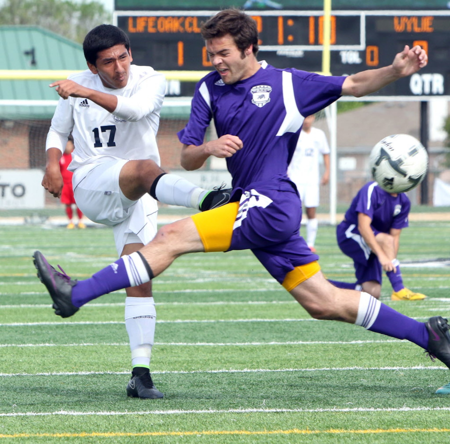 Life Oak Cliff's Jeffrey Torres (17) narrowly clears a shot on goal past the flying defense...