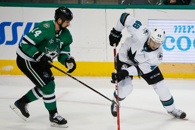 San Jose Sharks center Tomas Hertl (48) keeps the puck away from Dallas Stars left wing...