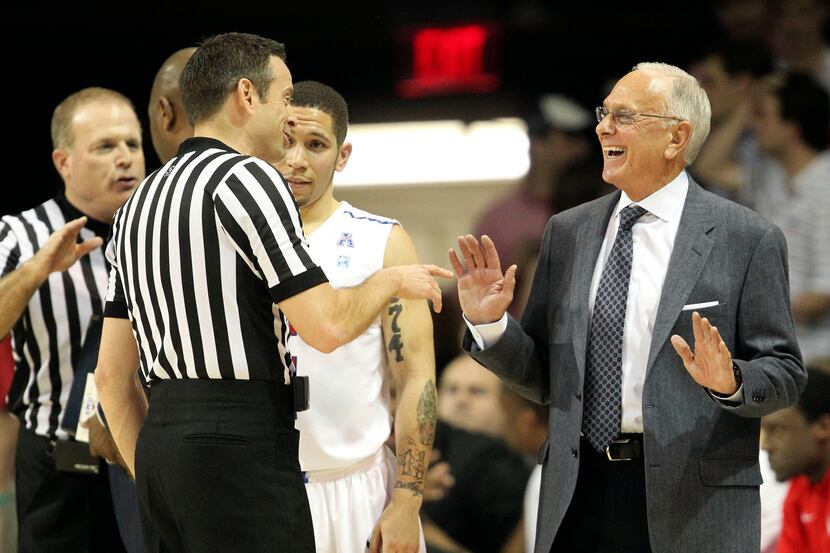 Southern Methodist Mustangs head coach Larry Brown shares a laugh with a referee during the...