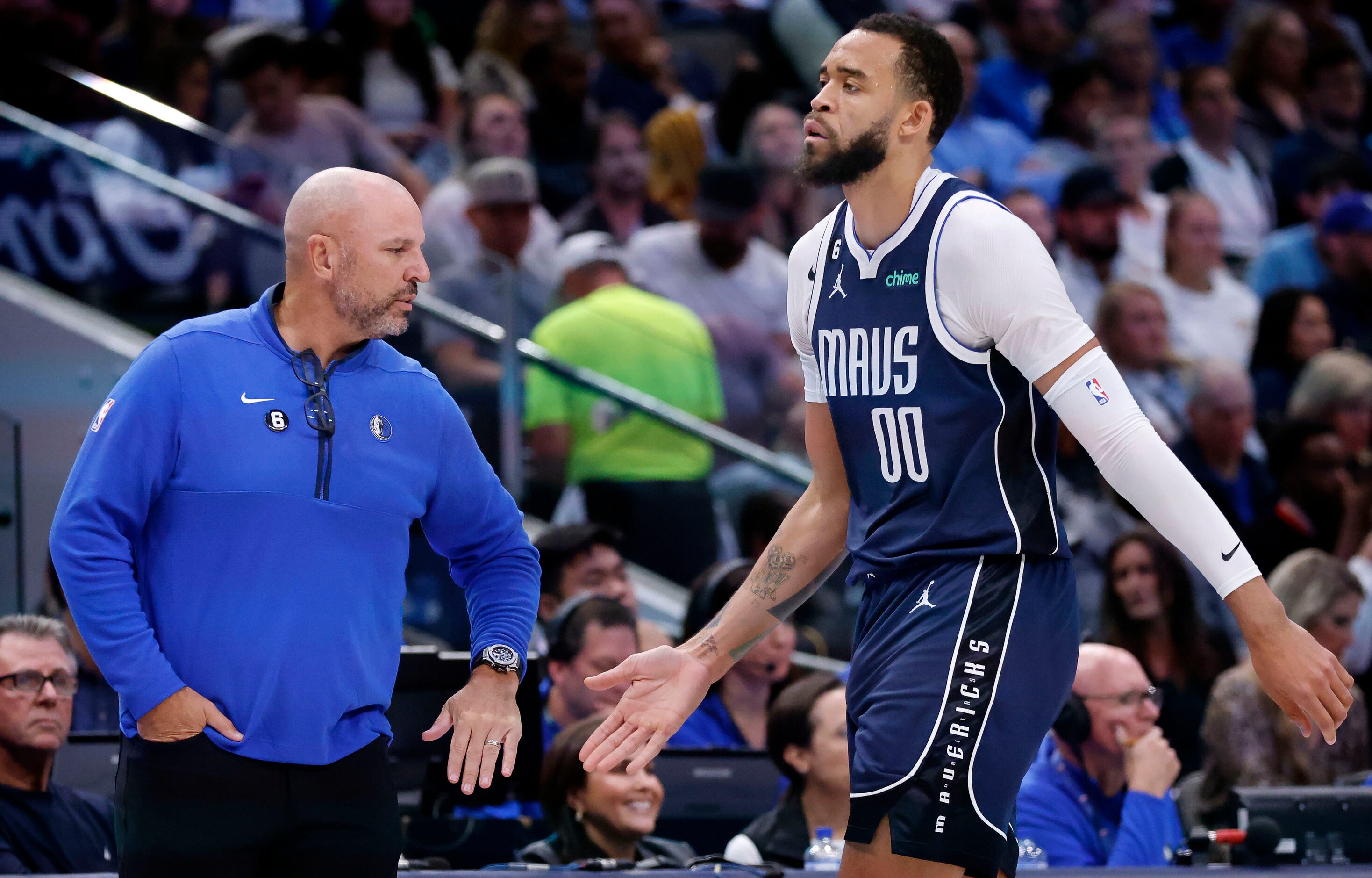 Dallas Mavericks center JaVale McGee (00) slaps hands with center JaVale McGee (00) as he...