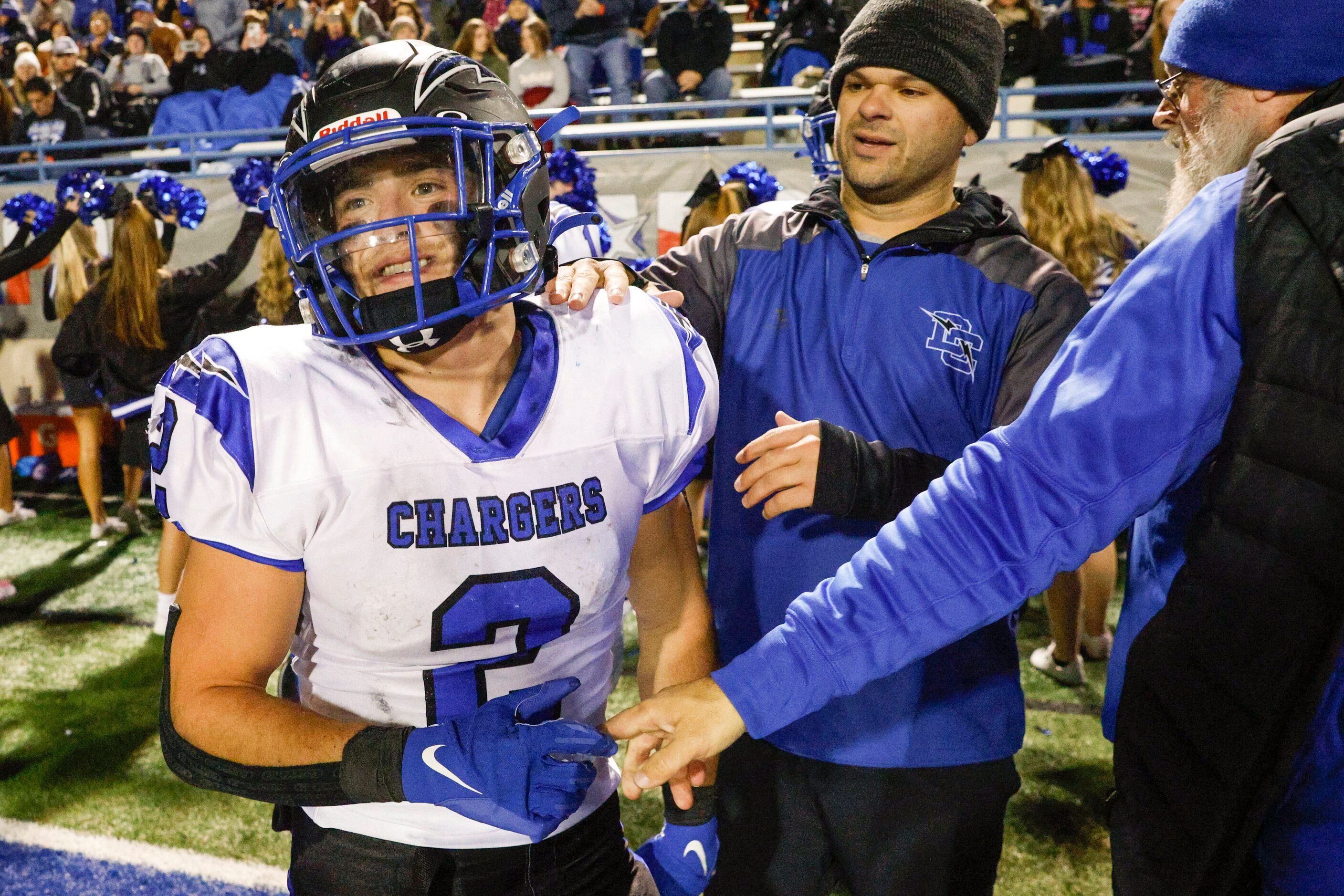 Dallas Christian coaches congratulate running back Zachariah Hernandez (2) during the fourth...