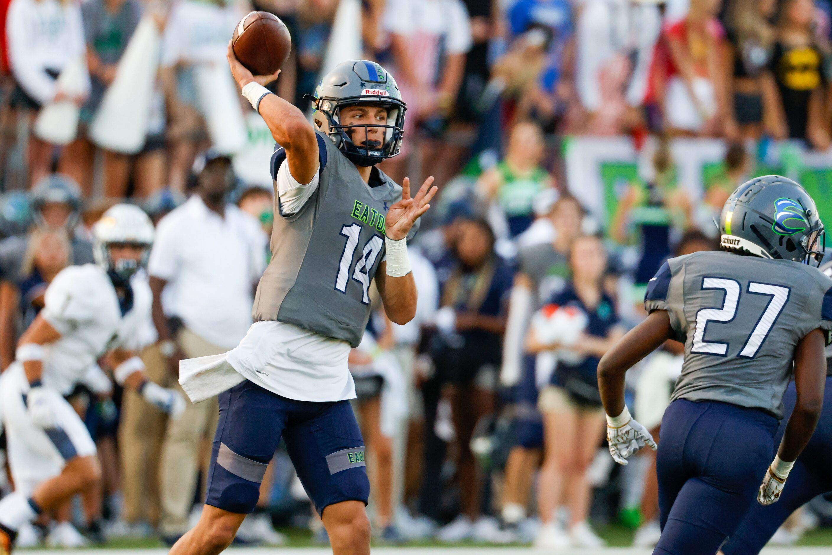 V.R. Eaton High School quarterback Noah Lugo (14) prepares a pass during the first quarter...