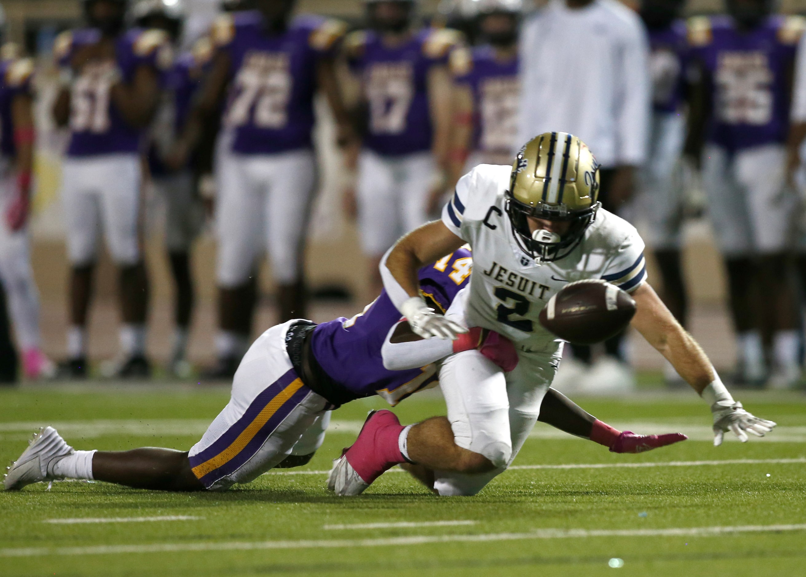 Richardson defensive back Chad Watson (14) forces Jesuit wide receiver Henry Bourret (2) to...