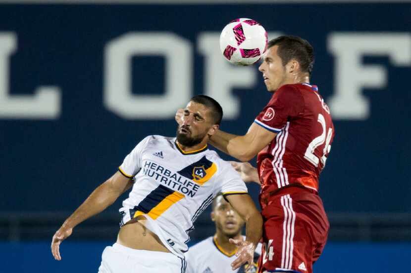 FC Dallas defender Matt Hedges (24) heads the ball over LA Galaxy midfielder Sebastian...