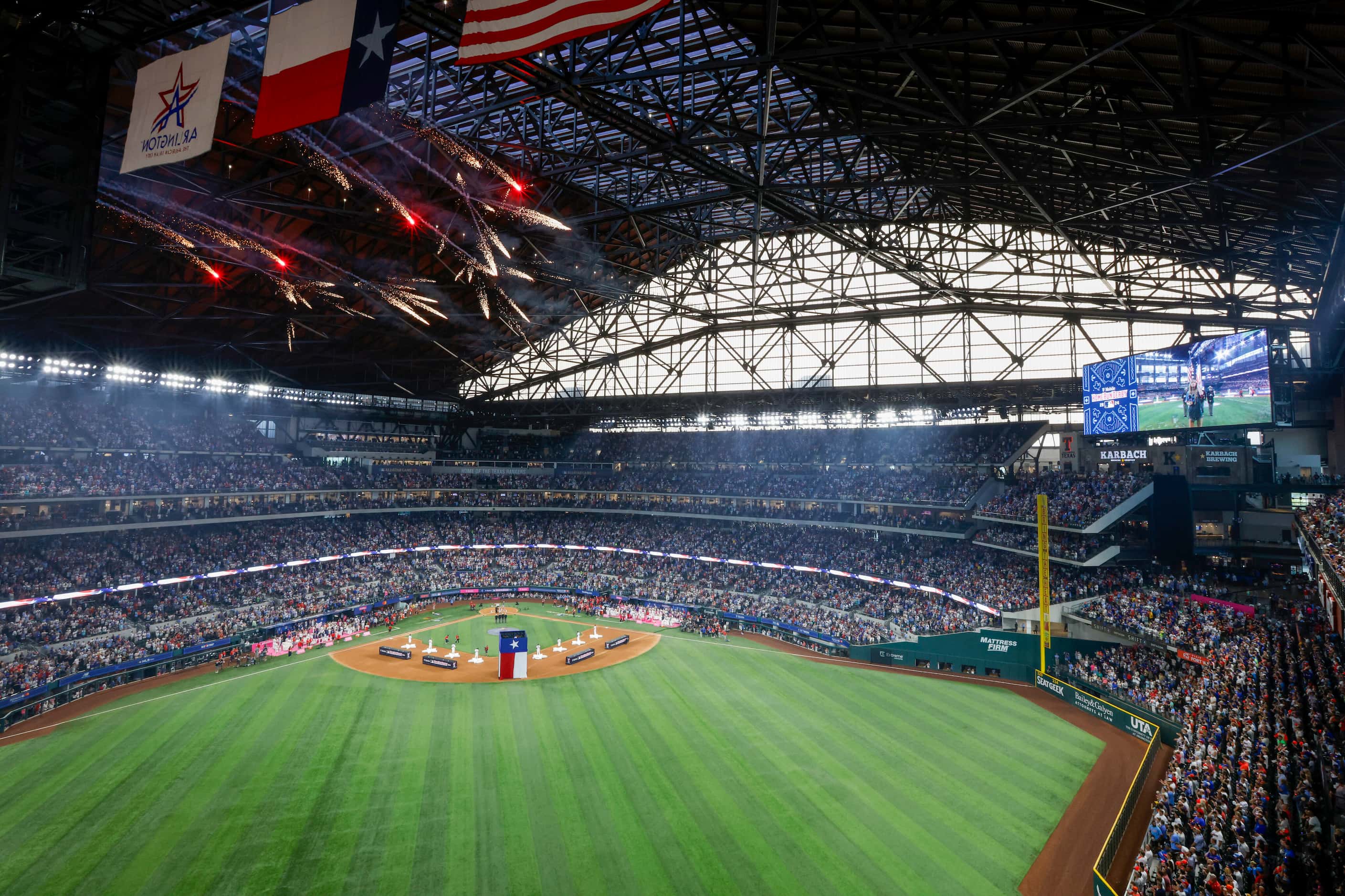 Fireworks burst over Globe Life Field during the national anthem at the MLB Home Run Derby,...