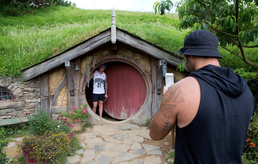 Tourists take photos during a tour of the Hobbit movie set near Matamata, New Zealand.