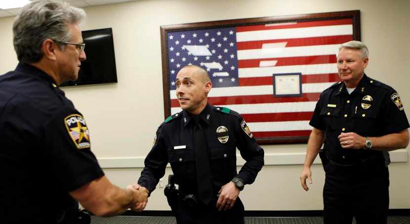 
Rockwall Police Officer Bryan Pate (center) receives congratulations from Assistant Police...